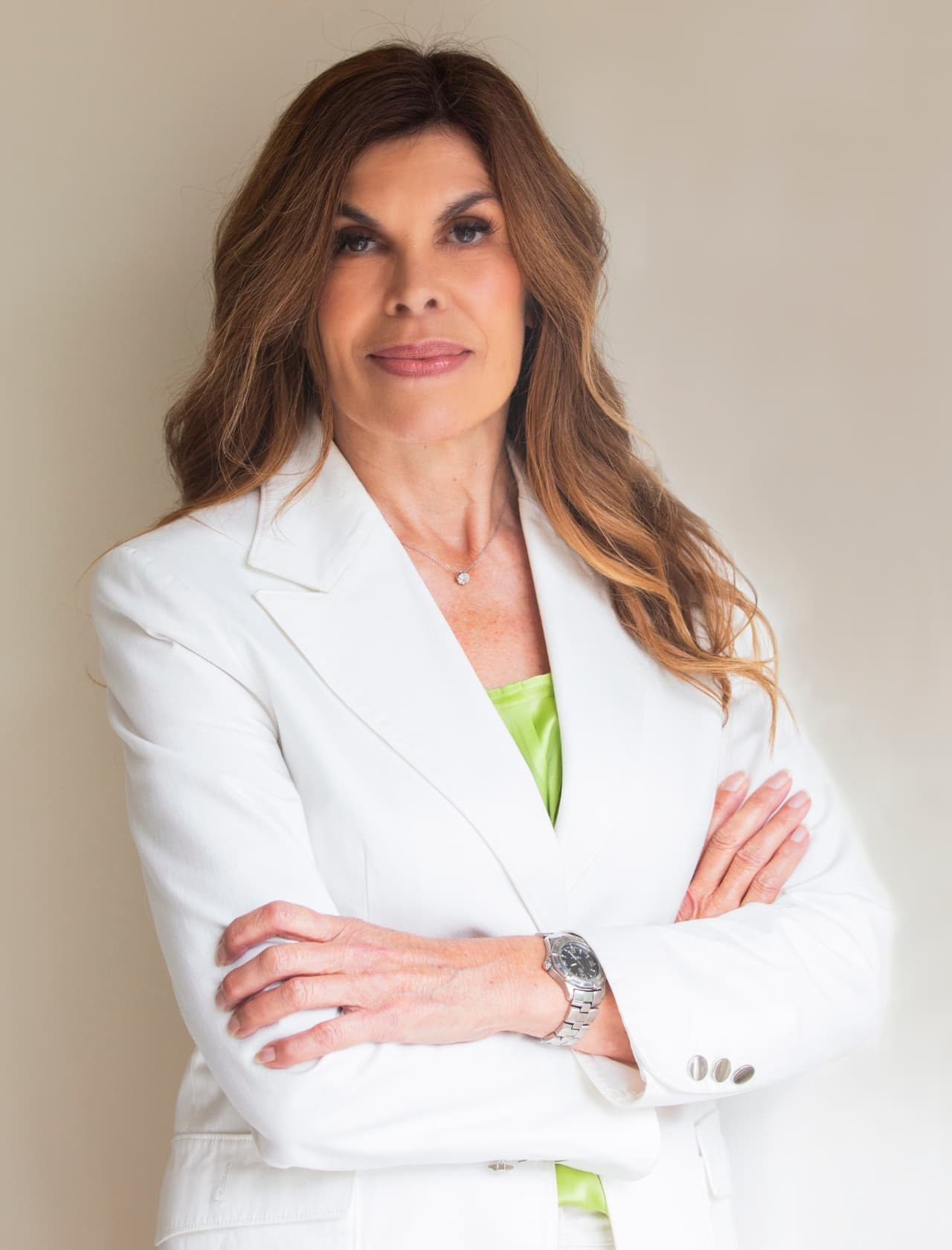 Sarah Sparks in a white suit with arms crossed